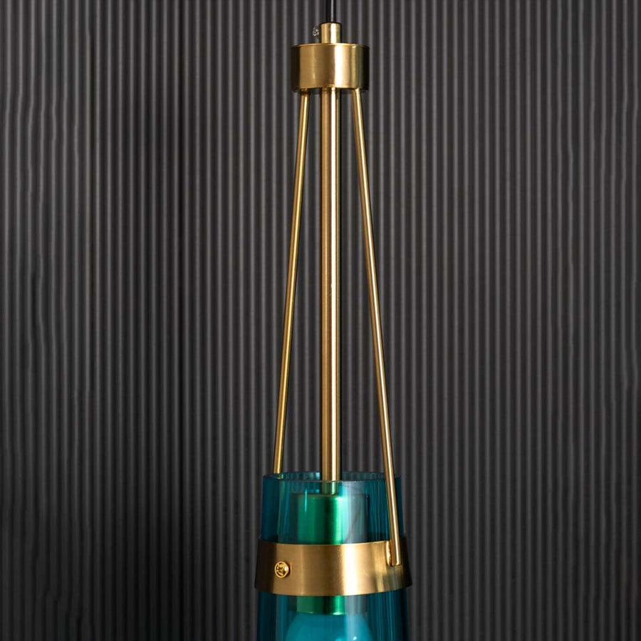Closeup view of the blue glass pendant light focusing on the gold frame connection and smooth tinted glass surface for detailed visual clarity.