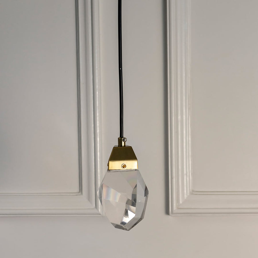 Elegant crystal pendant light with golden holder displayed on white background perfect for stylish home decor.