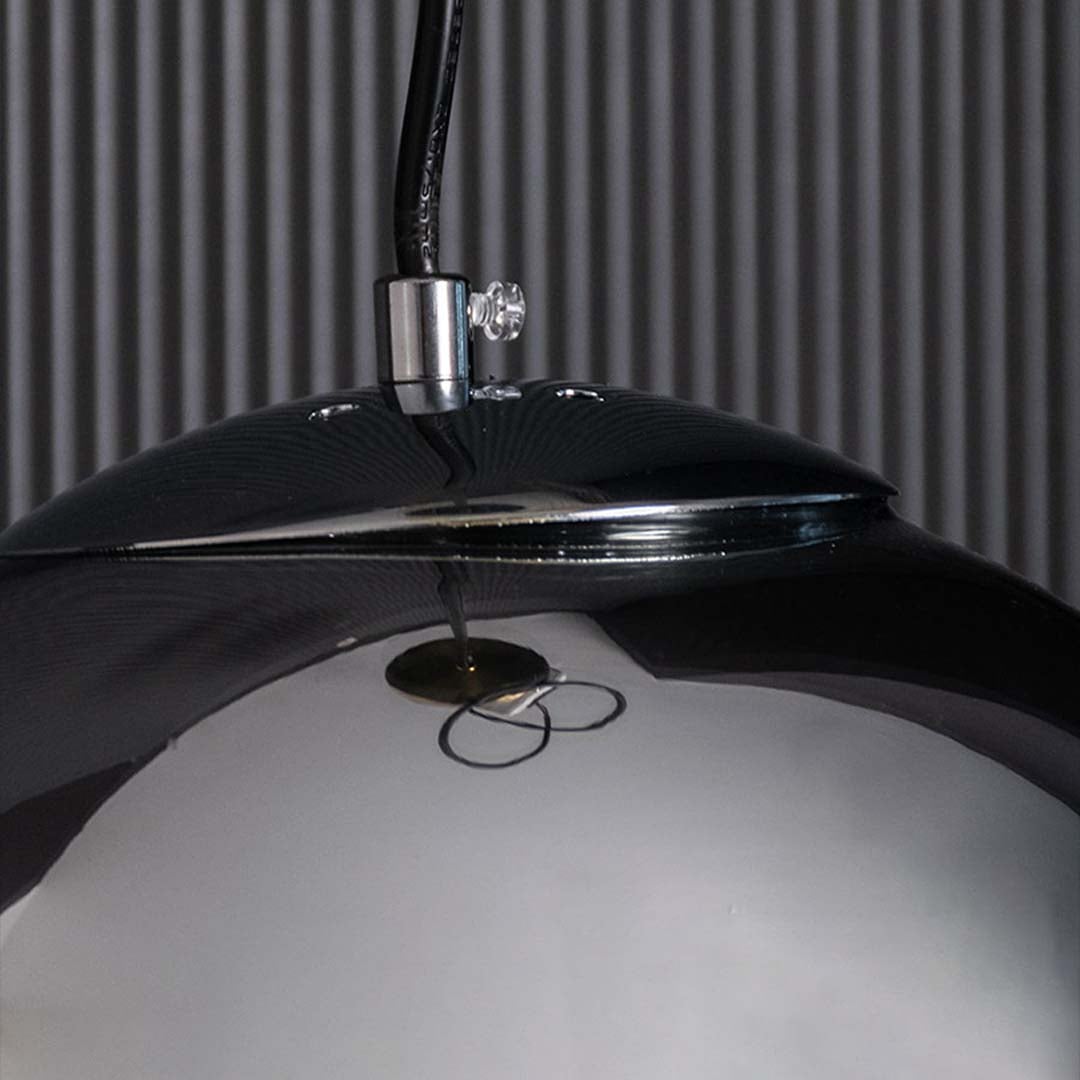 A detailed close view showing the smoked glass globe and warm glow creating a stylish modern lighting accent for contemporary spaces.