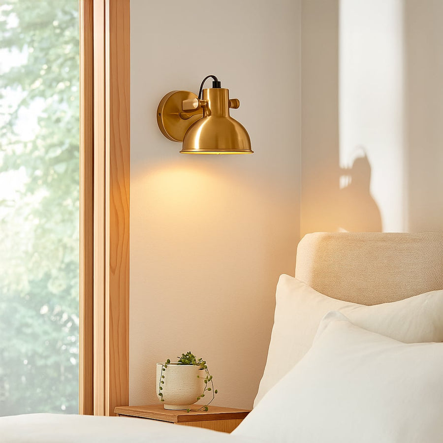 Gold metal wall light mounted beside sofa creating warm focused lighting ideal for reading corners and elegant living room Decor.