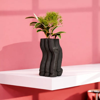 Black ceramic textured floor vase with sculpted organic design perfect for dried flower display in living room corner and modern home decor.