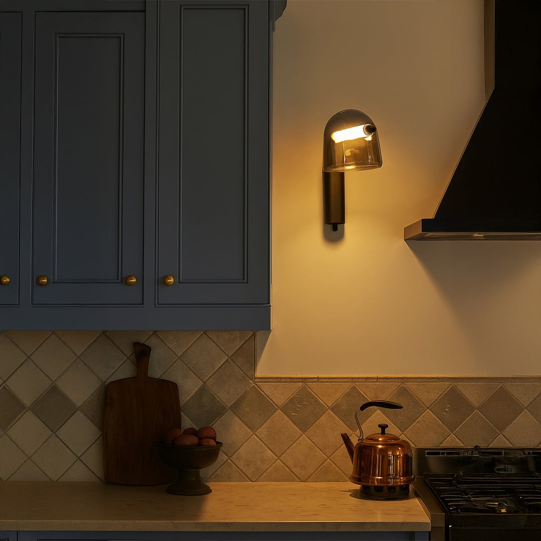 Smoked glass wall light with black metal base glowing warm in modern kitchen interior perfect for stylish home lighting.