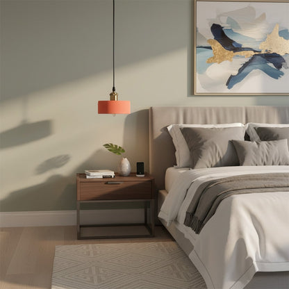 Terracotta pendant light glowing warmly beside a cozy modern bed with neutral bedding and a wooden nightstand.