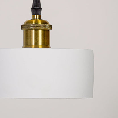 White glass pendant light closeup highlighting smooth cylindrical shade and gold metal fitting for elegant interior ceiling lighting.
