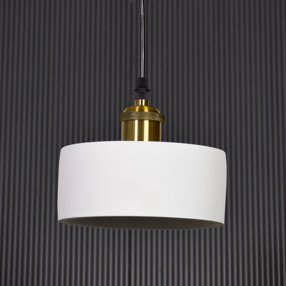 White metal pendant light with gold holder switched off on black background highlighting simple form and premium finish.