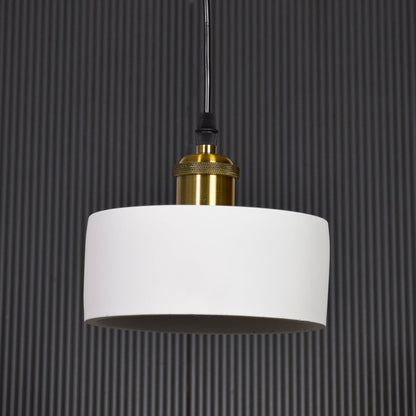 White metal pendant light with gold holder switched off on black background highlighting simple form and premium finish.