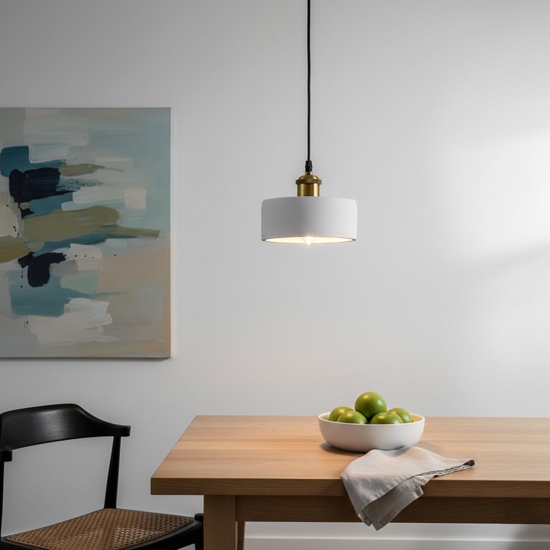 White metal pendant light with gold holder styled in modern interior creating clean minimal ceiling lighting for elegant homes.