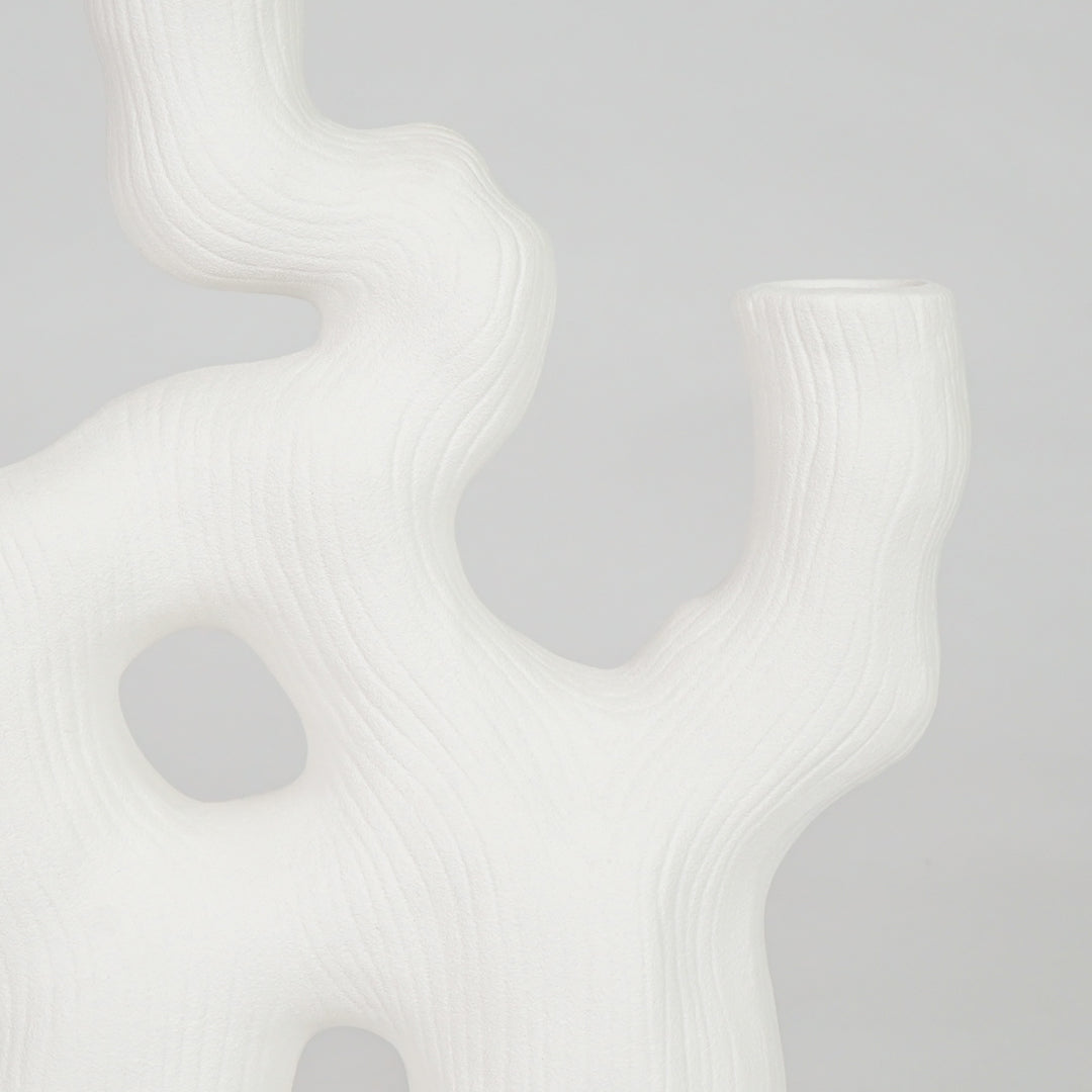 Closeup image of white ceramic coral decor sculpture for modern shelf styling with smooth matte artistic finish.