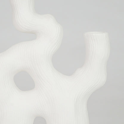 Closeup image of white ceramic coral decor sculpture for modern shelf styling with smooth matte artistic finish.