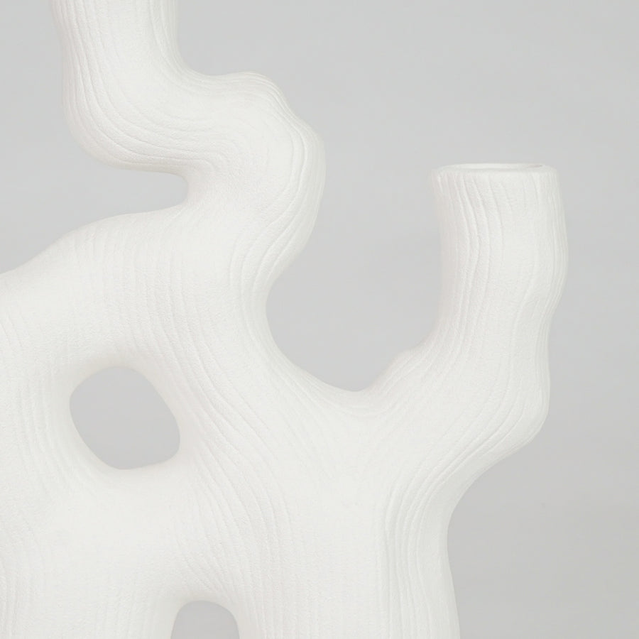 Closeup image of white ceramic coral decor sculpture for modern shelf styling with smooth matte artistic finish.