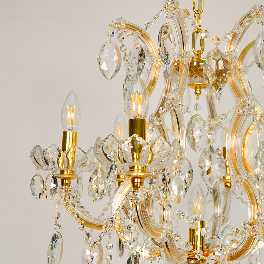 Closeup image of elegant clear crystal chandelier for luxury living room decor styling with shiny polished metal finish.