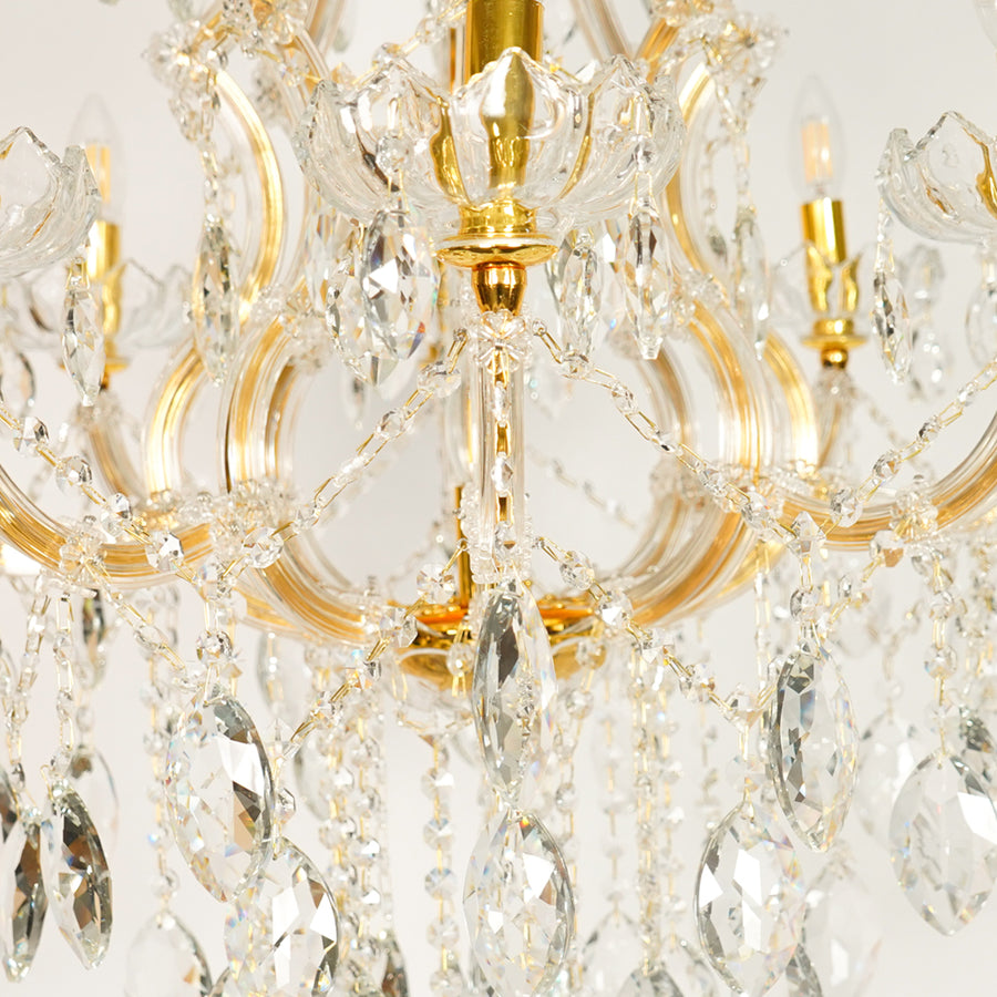 Closeup image of large clear crystal chandelier for luxury living room decor styling with elegant polished metal finish.