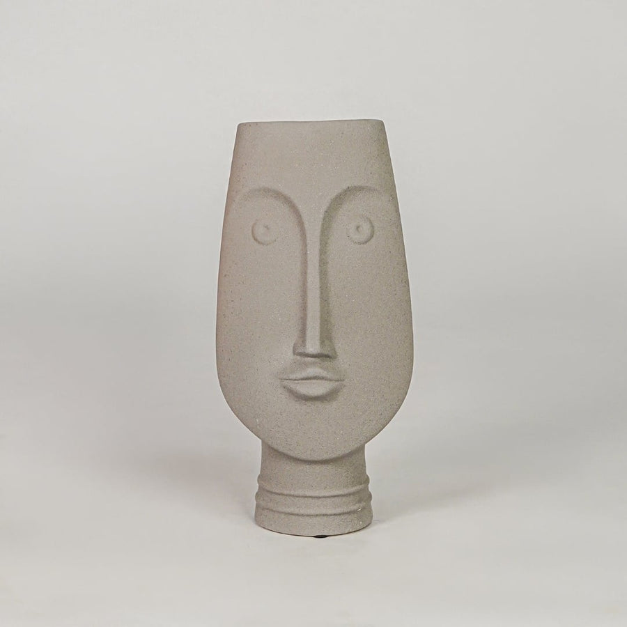 Beige face ceramic vase for modern shelf placement and elegant indoor home decor styling accent piece.