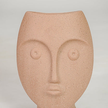 Closeup image of peach ceramic face decor sculpture for modern tabletop styling with artistic matte texture finish.