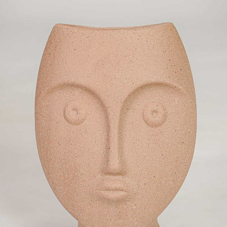 Closeup image of peach ceramic face decor sculpture for modern tabletop styling with artistic matte texture finish.
