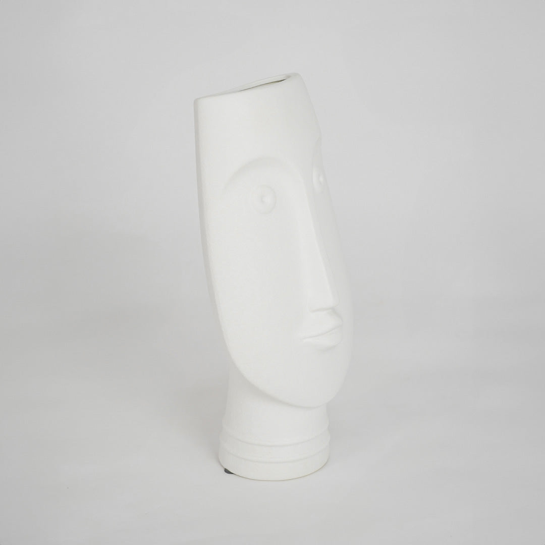 White sculptural ceramic vase for modern shelf placement and elegant indoor home decor styling accent piece.