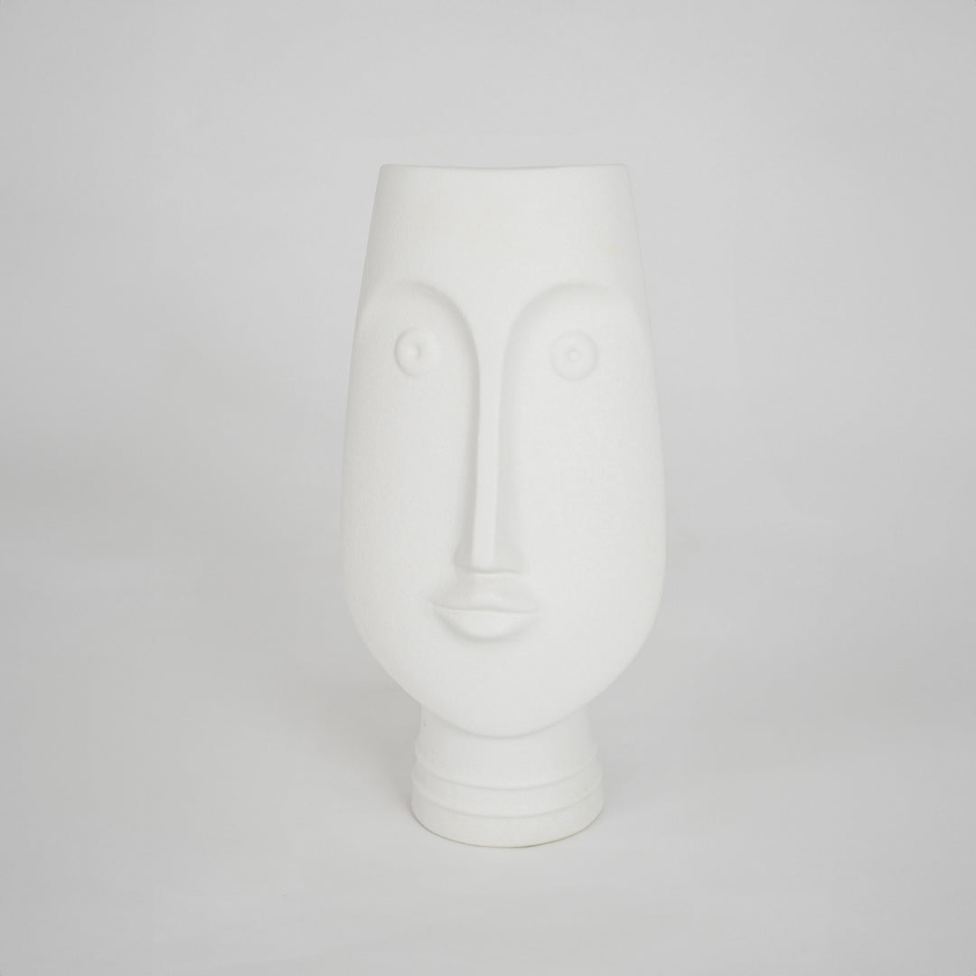 White sculptural ceramic vase for stylish shelf placement and modern living room decor styling accent piece.
