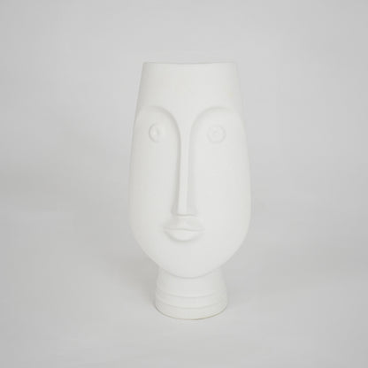 White sculptural ceramic vase for stylish shelf placement and modern living room decor styling accent piece.
