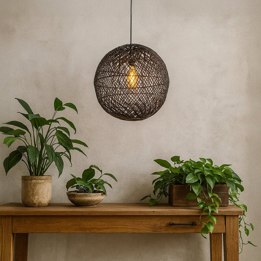 Elegant black round rattan pendant light creating a warm and inviting ambience in modern living or dining room interiors.