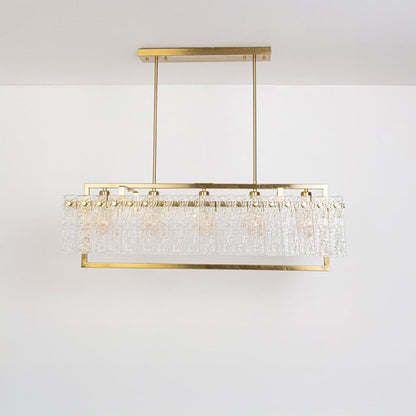 Gold rectangular chandelier with crystal accents turned off on white background displaying elegant dining room fixture design.