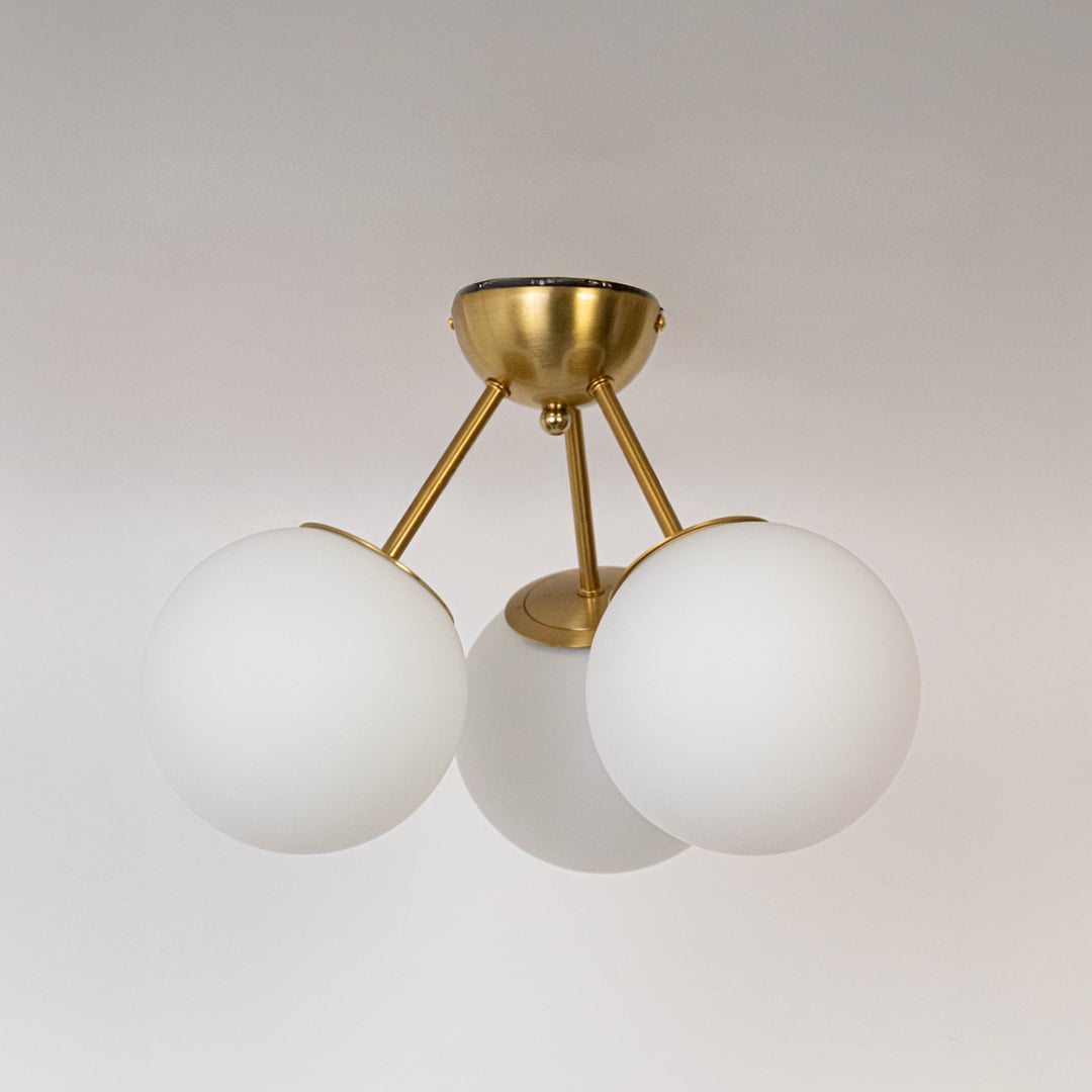 Gold ceiling light with frosted glass globes and metal frame in off mode displayed on white background for ceiling lighting.