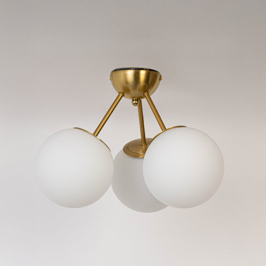 Gold ceiling light with frosted glass globes and metal frame in off mode displayed on white background for ceiling lighting.