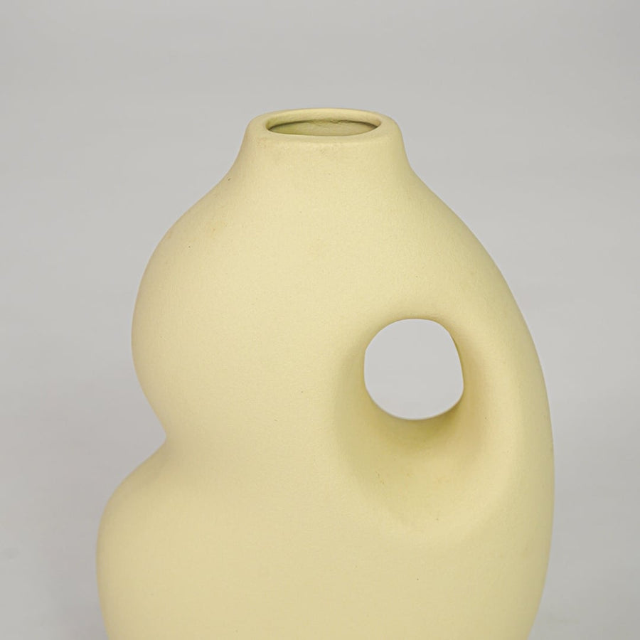 Yellow ceramic decorative vase closeup modern flower vase for shelf console table living room home decor styling.