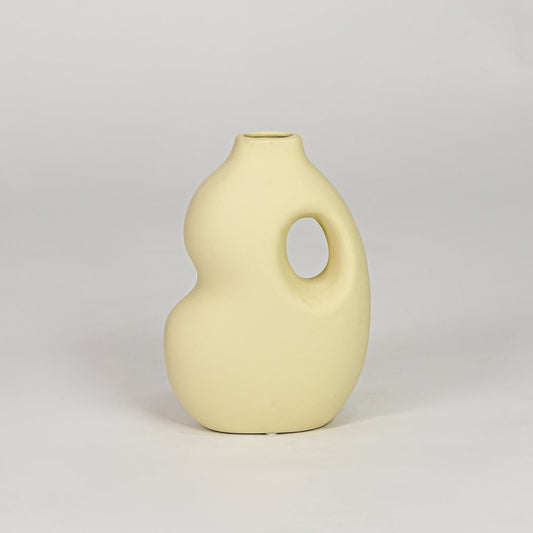 Yellow ceramic decorative vase with modern design flower vase for tabletop shelf console living room decor styling.