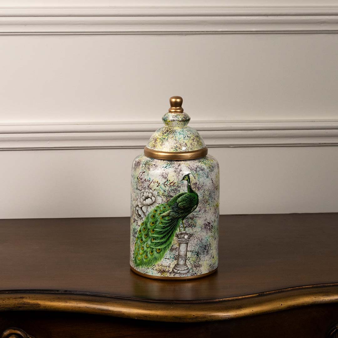 Decorative ceramic jar with hand painted green bird motif displayed on white background adding artistic charm to tabletop Decor styling.