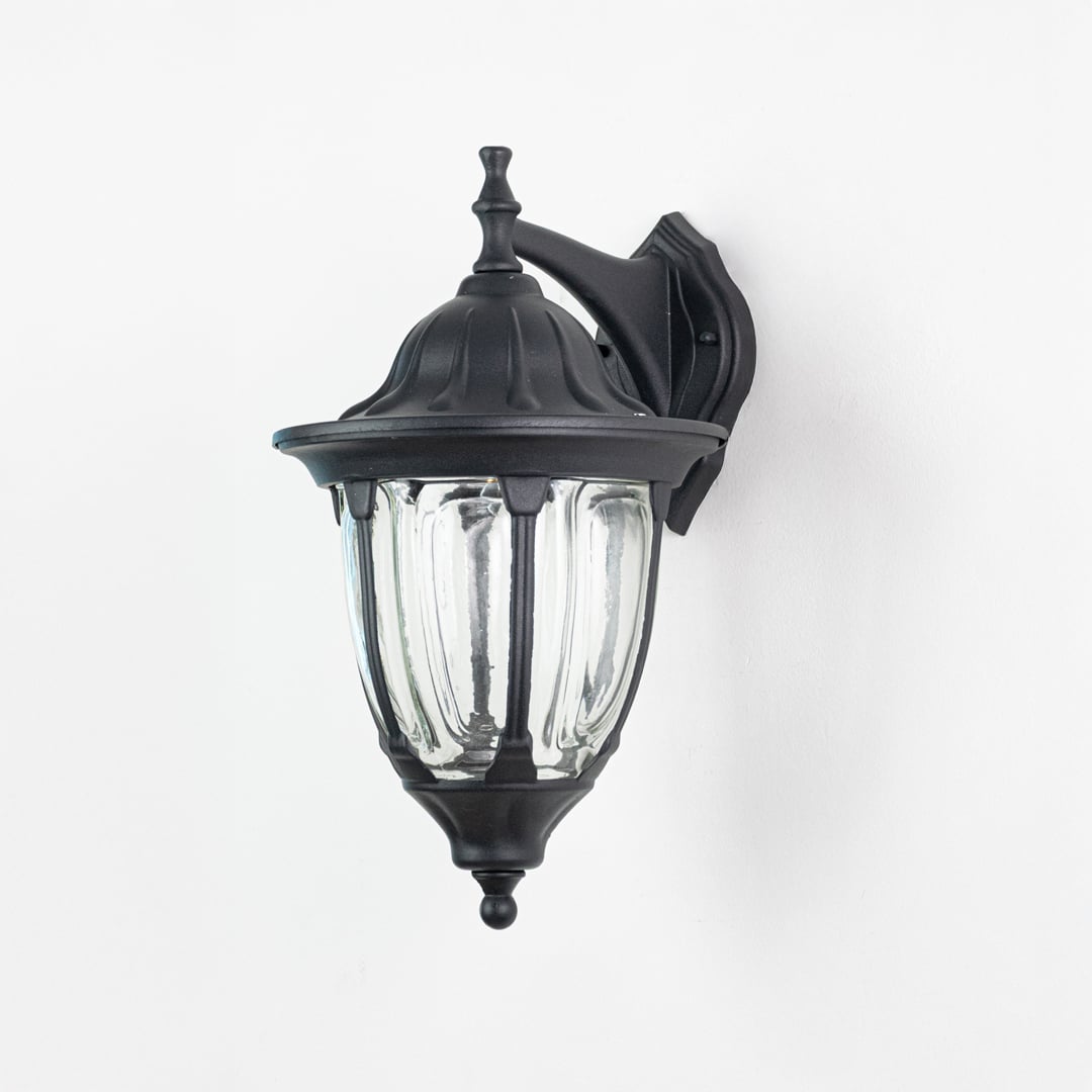 Outdoor wall lantern in black metal with clear glass displayed on white background highlighting classic exterior lighting style.