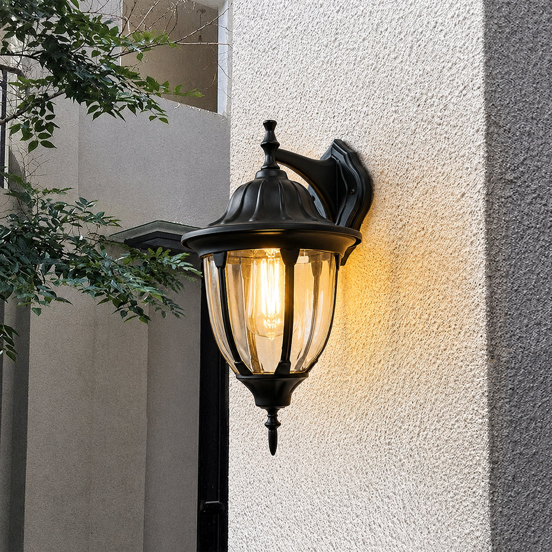 Black metal outdoor wall light lifestyle image with warm glow for elegant exterior entryway decor.