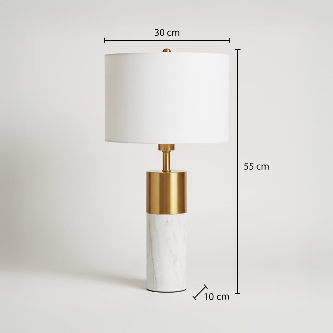 White marble table lamp shown unlit on white background featuring brass metal accent and clean cylindrical modern design.