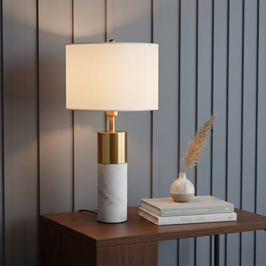 White marble table lamp with brass metal detail and fabric shade styled on console creating elegant modern living room lighting.