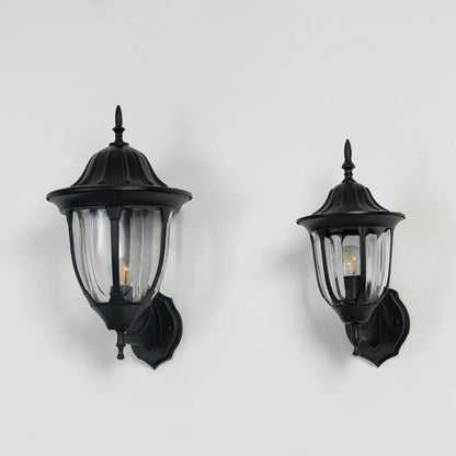 Collection of black outdoor wall mount lanterns switched off on white background displaying classic exterior light fixtures.