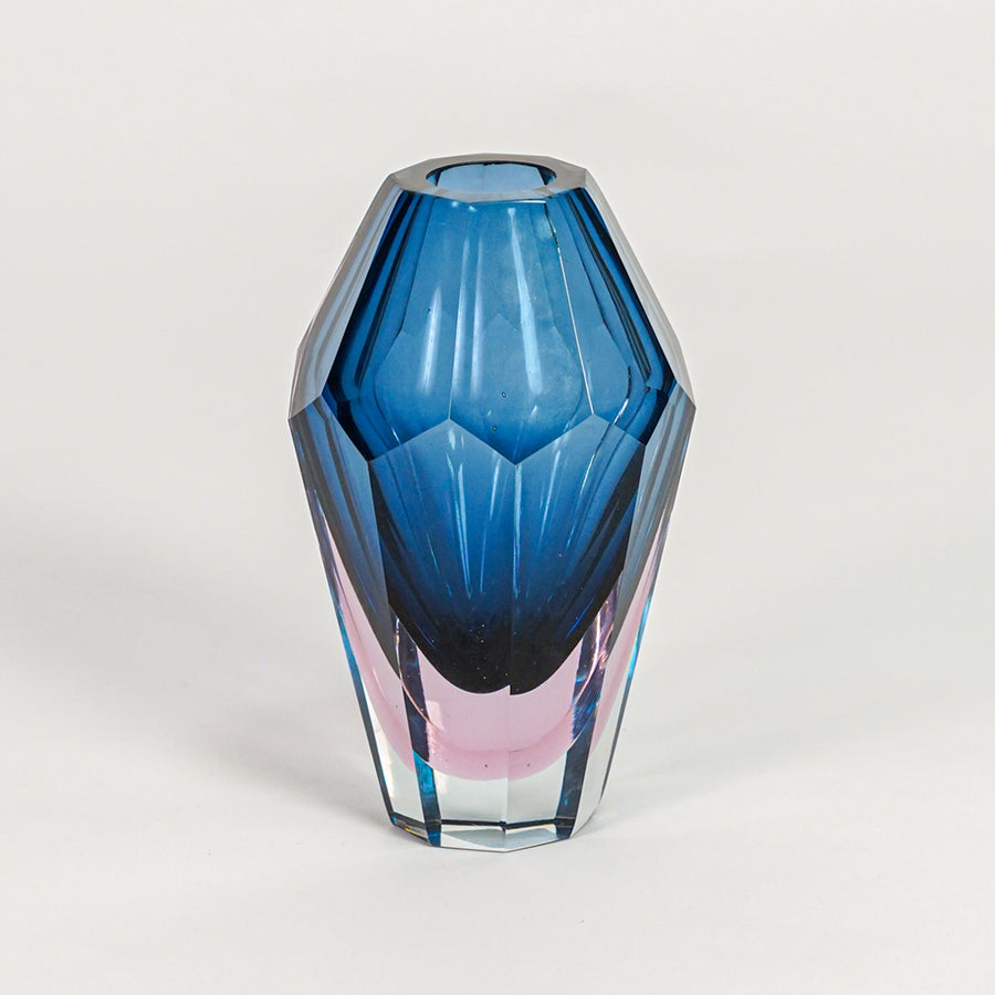 Geometric blue glass vase with sleek modern shape for vibrant home decor and stylish tabletop centerpiece display.