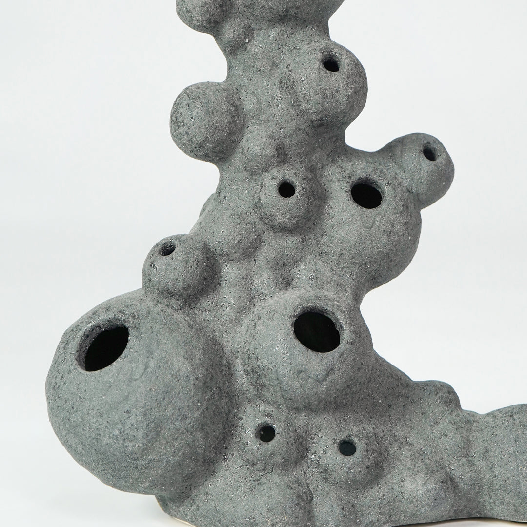 Closeup image of grey ceramic coral decor sculpture for modern shelf styling with artistic textured finish display.