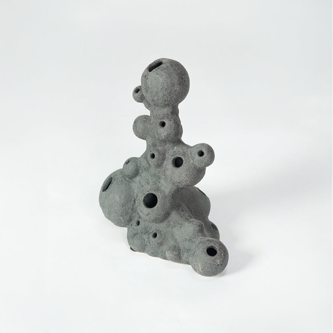 Grey textured ceramic decor object for modern shelf placement and artistic indoor living room styling accent piece.