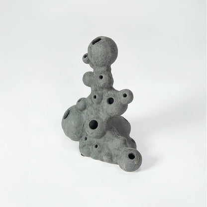 Grey textured ceramic decor object for modern shelf placement and artistic indoor living room styling accent piece.