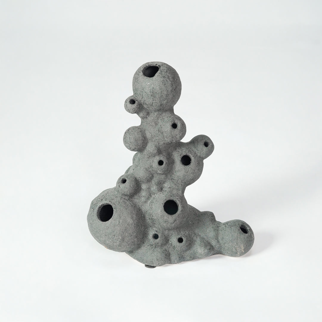 Grey textured ceramic decor object for modern shelf placement and artistic indoor living room styling accent piece.