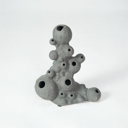 Grey textured ceramic decor object for modern shelf placement and artistic indoor living room styling accent piece.
