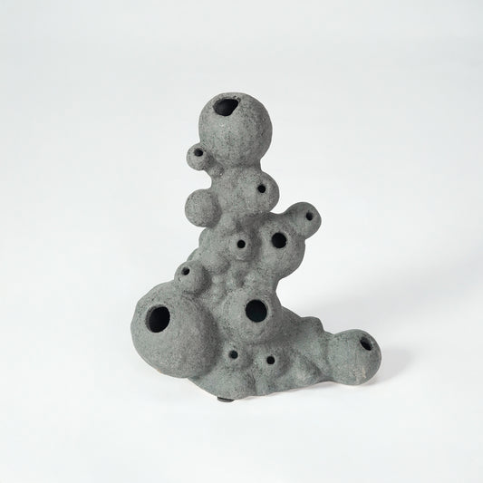 Grey textured ceramic decor object for modern shelf placement and artistic indoor living room styling accent piece.