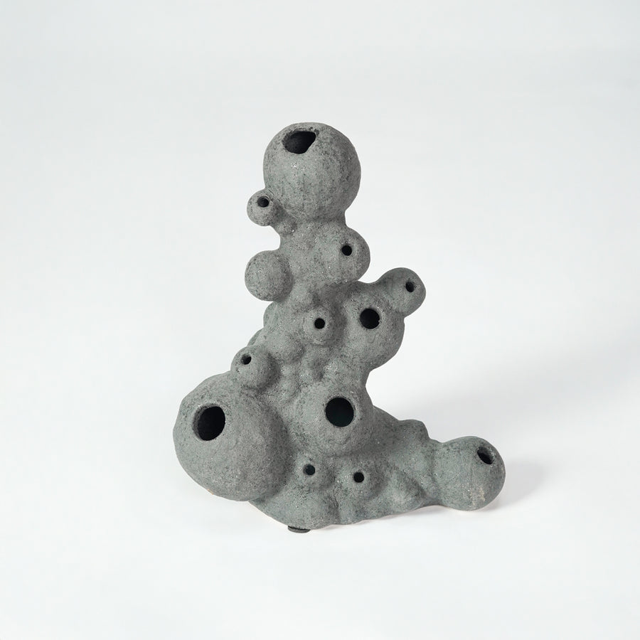 Grey textured ceramic decor object for modern shelf placement and artistic indoor living room styling accent piece.