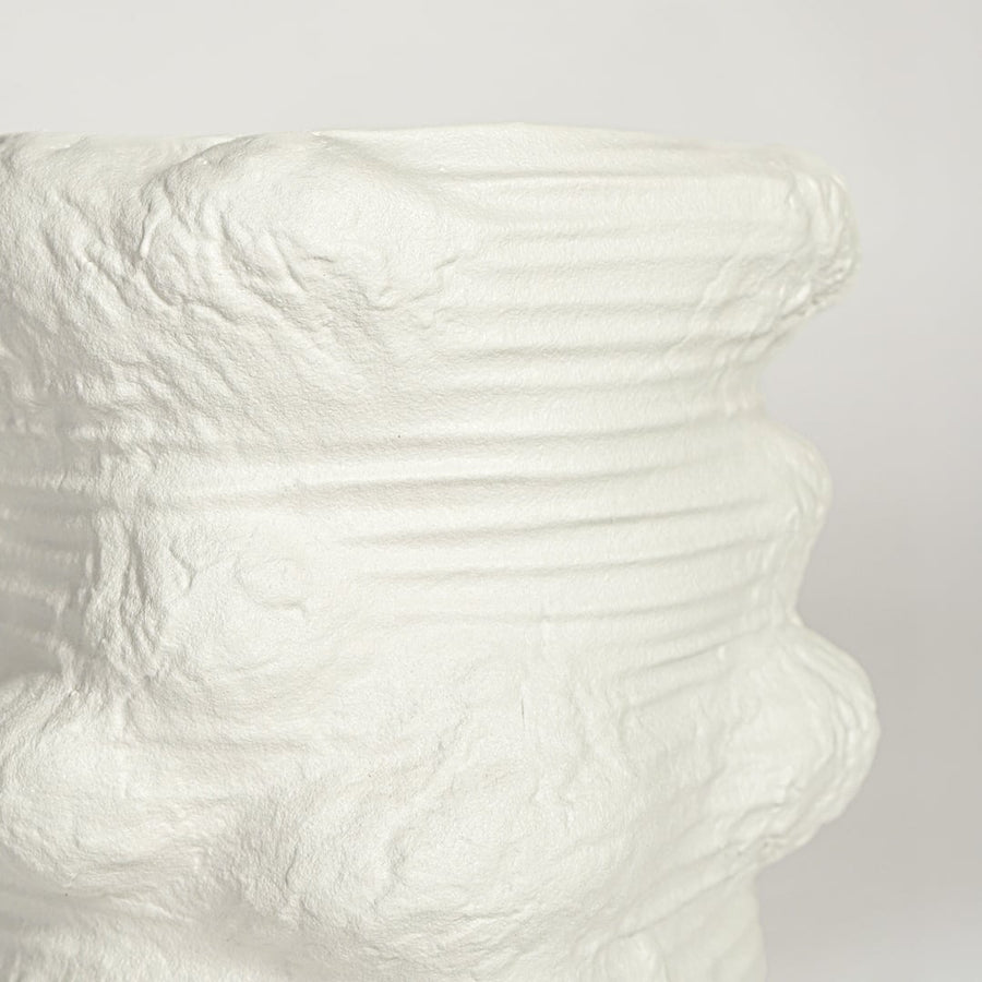 Close up view white ceramic planter showing organic textured surface matte finish modern decorative plant pot styling.