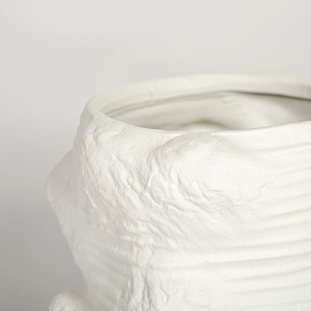 Detailed close up white textured ceramic planter showing sculpted ridges handmade finish modern decor accent.