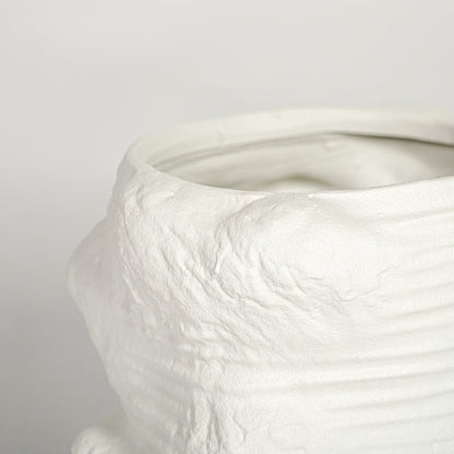 Detailed close up white textured ceramic planter showing sculpted ridges handmade finish modern decor accent.