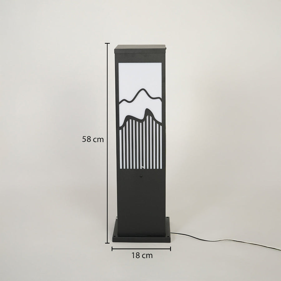 Modern outdoor bollard light with black metal frame and mountain pattern diffuser on neutral background 58 cm height 18 cm width ideal for garden pathway lighting.