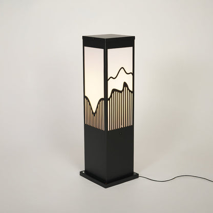 Outdoor bollard light with black metal frame and patterned glass panel on neutral background ideal for modern garden or pathway lighting.