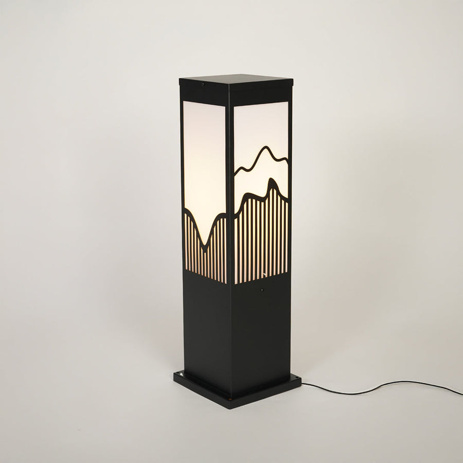 Outdoor bollard light with black metal frame and patterned glass panel on neutral background ideal for modern garden or pathway lighting.
