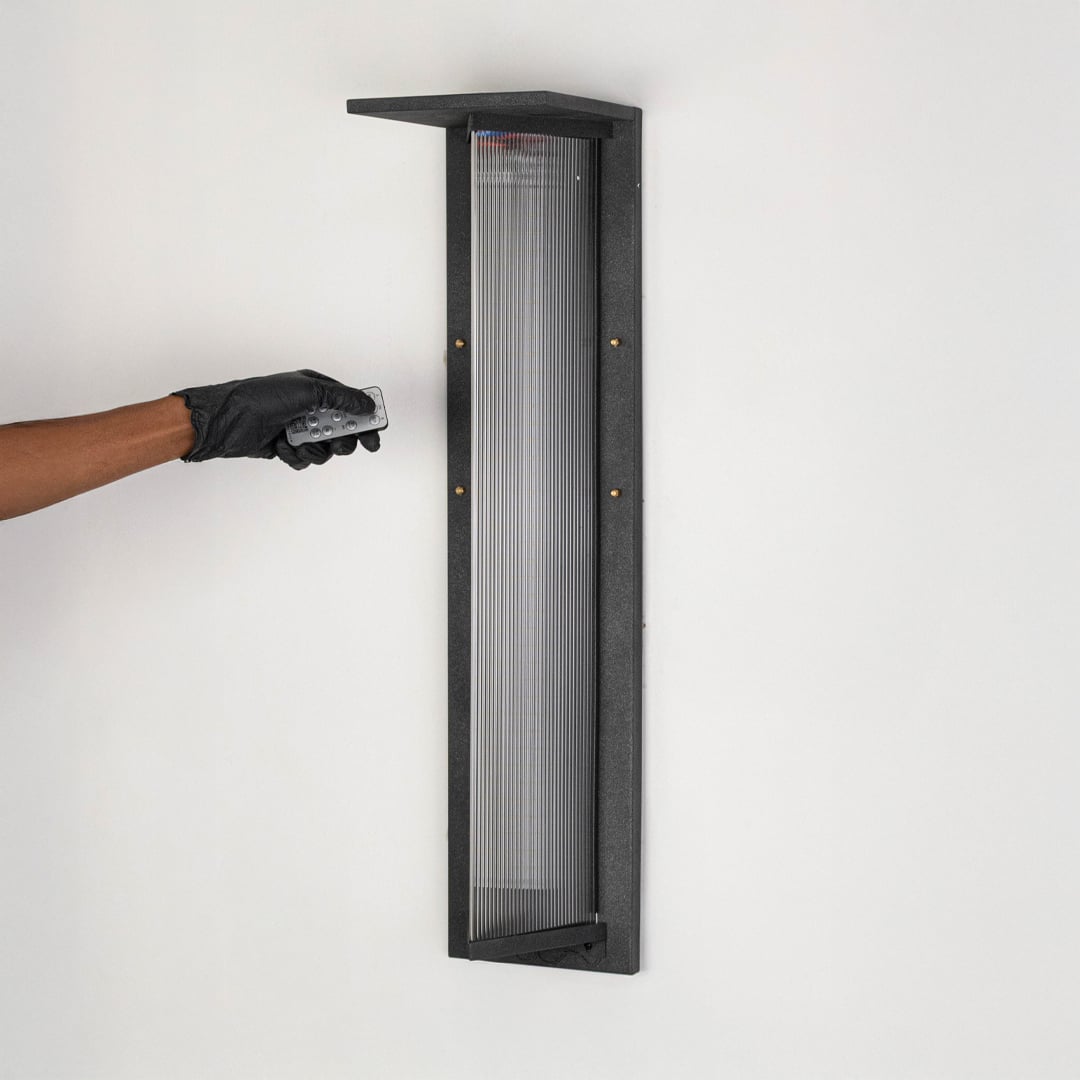 mundane solar glow outdoor wall sconce light off white background 1Stylish black wall light with ribbed glass diffuser displayed off on clean white background surface.