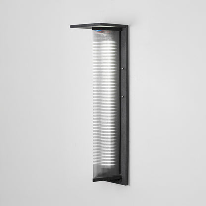 Black metal outdoor wall light on white background with ribbed glass shade for modern exterior decor.